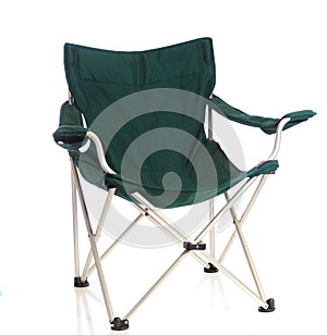 Green folding lawn chair on white