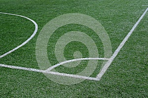 Green football field with white marking lines