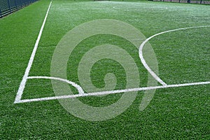 Green football field with white marking lines