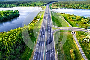 Green forest and asphalt road from above