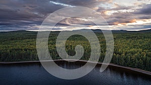Forest and lakeshore at Lake Siljan from above during sunset in Dalarna, Sweden photo