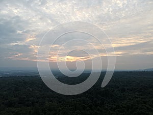 A green forest with sky background and blue white cloud in the morning at Bung Kan, Thailand.