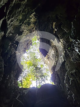 Green forest view from Gua Pagar in arch resembling Kelantan state map in Dabong, Kelantan, Malaysia. photo