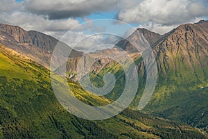 Green forested mountain range above Girdwood, Alaska, USA