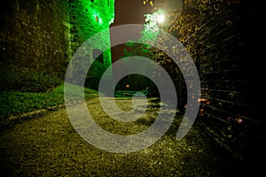 Green fortress wall at night