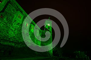 Green fortress wall at night