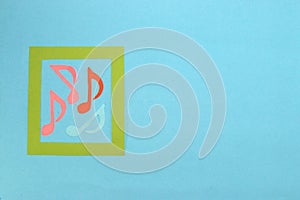green frame with musical notes around the frame pastel blue background with a lot of empty space