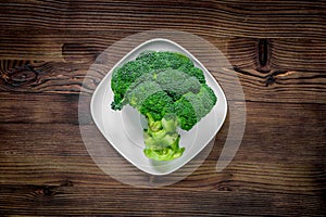 Green fresh broccoli for fitness diet food on wooden table background top view