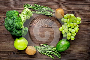 Green fresh food for fitness diet on wooden table background top view mock up