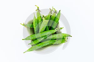 Green fresh pea pod many vegetables in a ceramic bowl on a white background group of beans