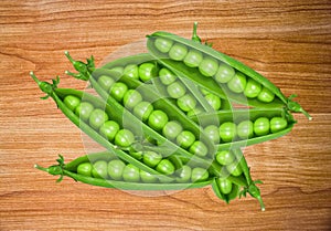 Green fresh peas on wooden table