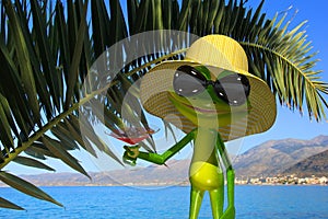 Green frog on the beach with a glass