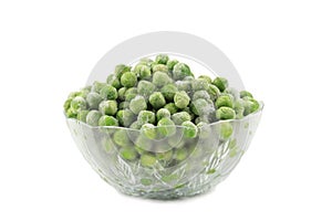 Green frozen peas in a glass dish.