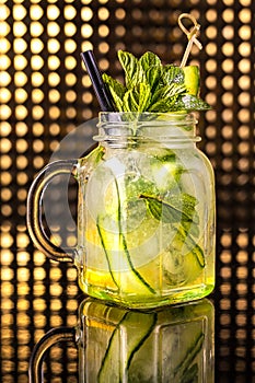 Green fruit cocktail lemonade with fresh cucumber in vintage jar