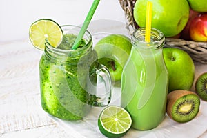 Green fruit and herbs juice in bottle, vegetable smoothie in jar mug,outdoors, summer spring sunlight spots