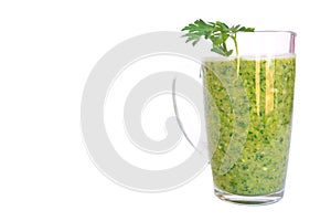 Green fruit and vegetable smoothie with a sprig of parsley in a transparent glass mug on a white background. healthy diet. food