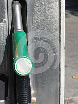 Green fuel pistol on gas station . Unleaded petrol at the pump station