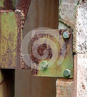 Green Galvanized Bolt on Rusty Steel Metal photo