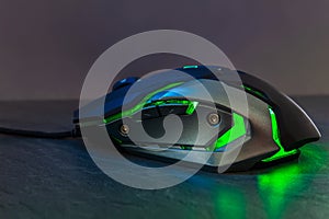 Green gaming mouse on stone texture table