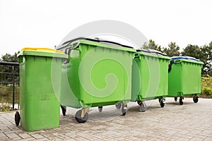 Green garbage containers in a row