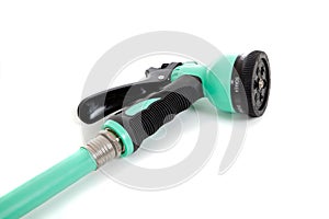 Green garden hose with spray nozzle