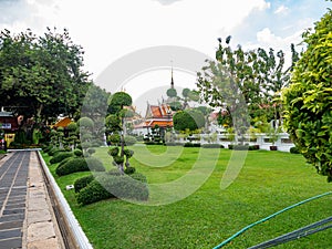 Green garden in the temple area and Add up peace Mentally,Temple name is Wat Arun Ratchawararam Woramahaviharn at Bangkok Thailand