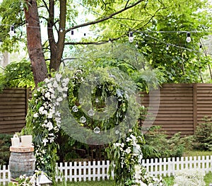 Green garden wedding arch with flowers