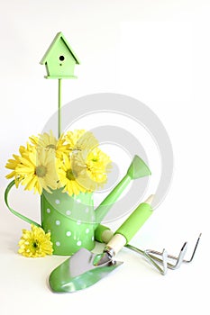 Green Gardening Tools with Yellow Flowers