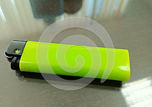 green gas lighter on the table