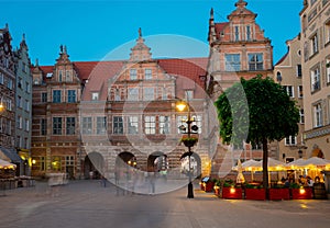 Green gate at Dluga Street in the old city center at nightin. Gdansk, Poland