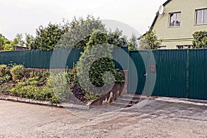 The green gate and the gate to the iron fences along the street