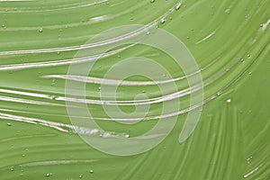 Green gel texture. Transparent skincare product  background. Aloe, herbal natural cosmetics