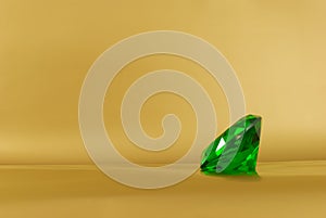 Green gem on a golden background