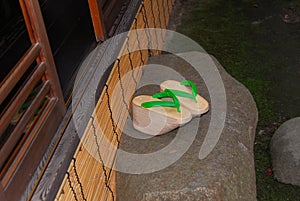 Green Geta sandals on stone in Japanese house