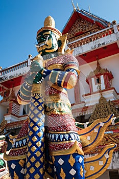 Green giant statue guarding Thai temple