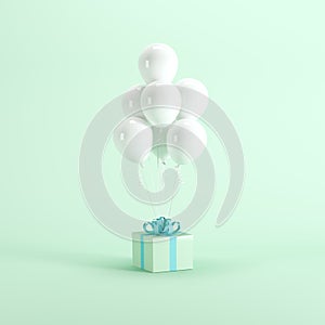 Green gift box with blue ribbon and white balloons on green pastel background