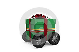 Green gift box with red ribbon on wheels