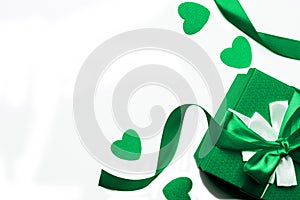 Green gift box with ribbon and hearts on a white background, isolated image