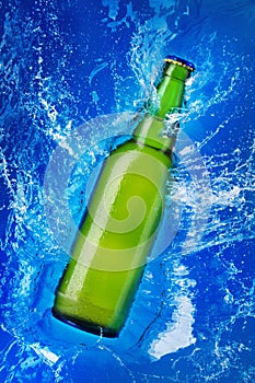 Green glass bottle in water