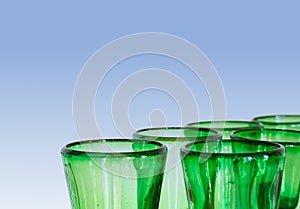 Green glass designer wine glasses detail view abstract with copy space