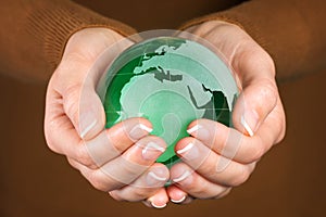 Green Glass globe in hand