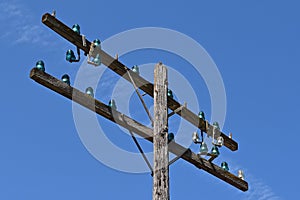 Green glass insulators on a telephone pole