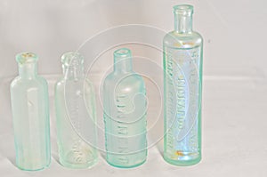 Green glass, medicine bottles with applied necks,