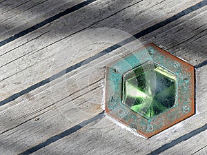 Green Glass Porthole on the Deck of an Antique Top Sail Schooner