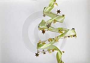 Green glitter ribbon in shape of Christmas tree on white background. Copyspace for text, congratulations, invitation