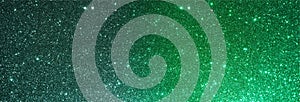 Green glitter textured background.