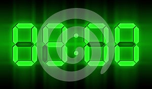 Green glowing neon digital clocks in the dark show 09:00 time