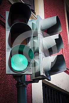 Green go light on traffic light on street corner