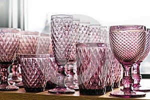 Green goblets and glasses for wine in the store on the counter transparent set collection embossed