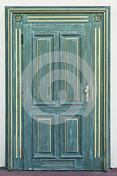 Green door with golden ornament